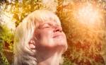 Attractive senior woman taking a deep breath while walking at the&nbsp;evening