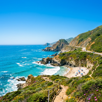 Clear sunny skies, brighter ocean and cliffs